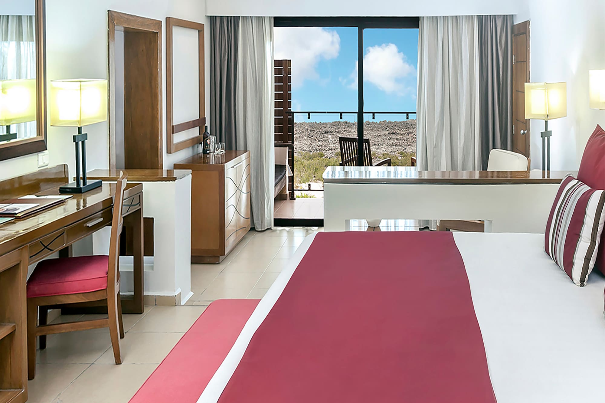 a bedroom with a large bed and a desk