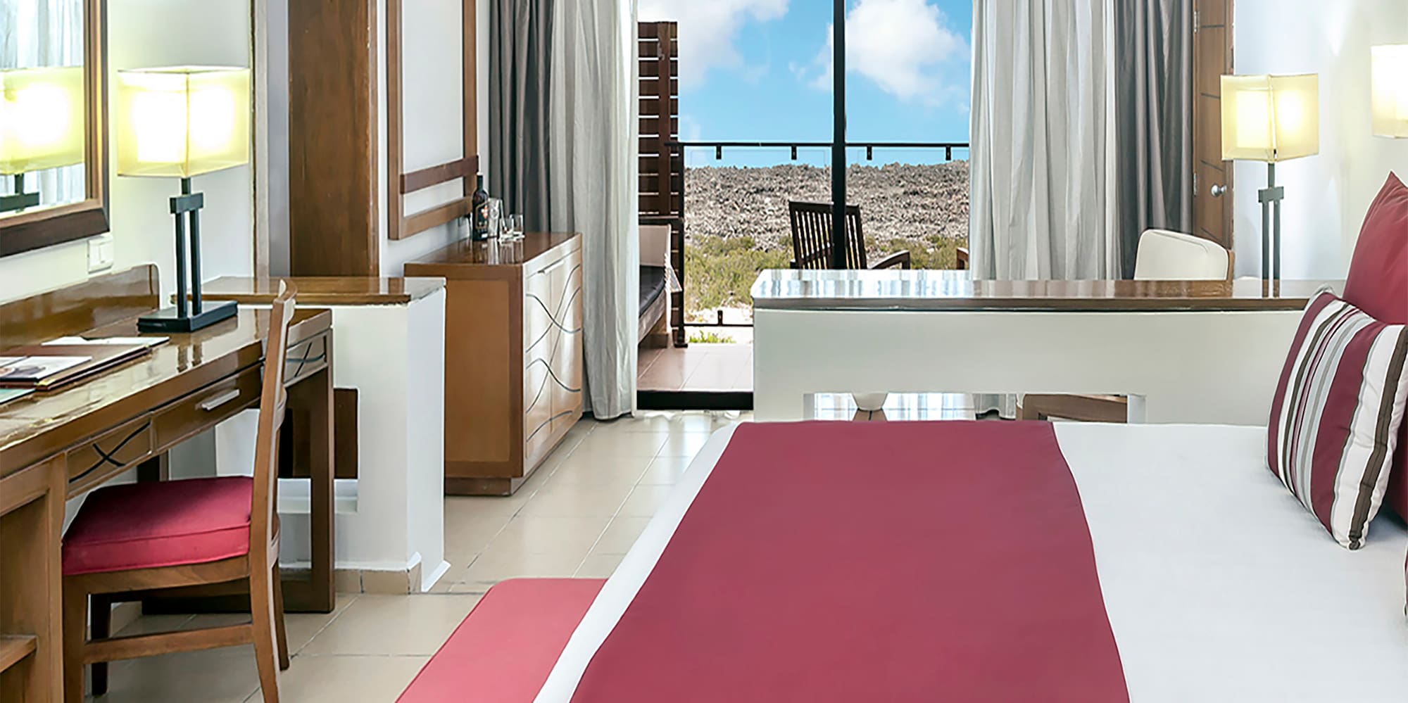 a bedroom with a large bed and a desk