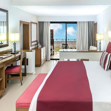 a bedroom with a large bed and a desk