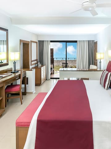 a bedroom with a large bed and a desk