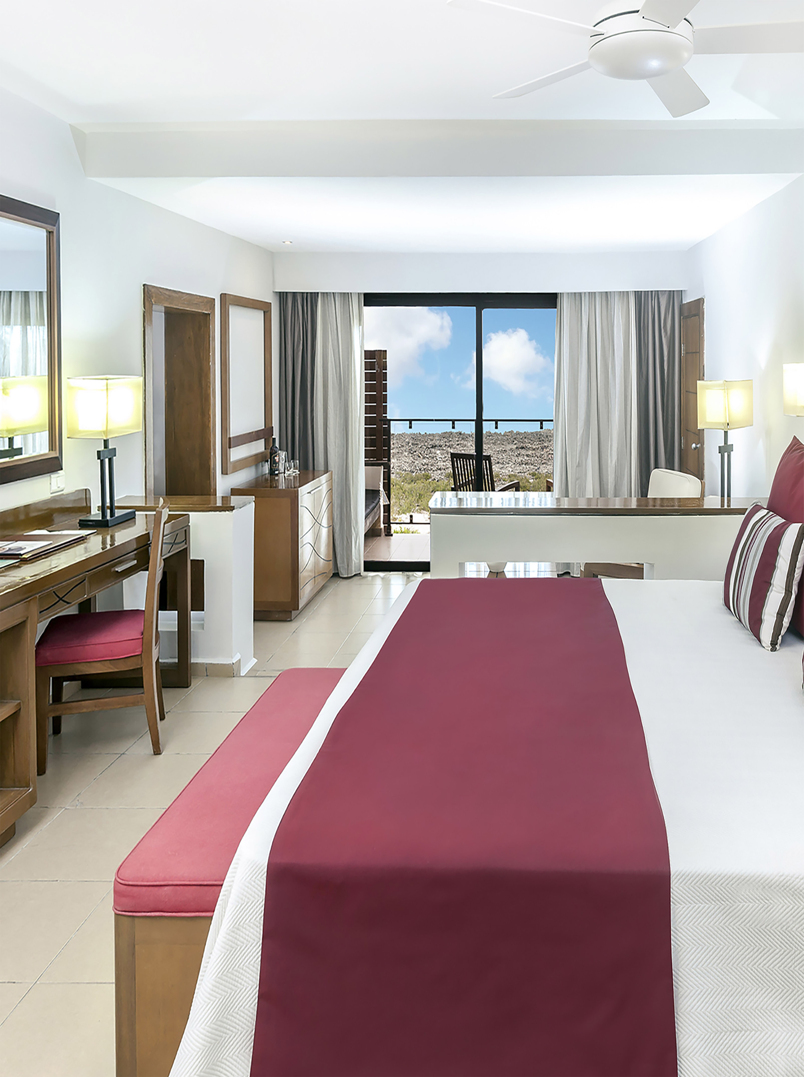 a bedroom with a large bed and a desk