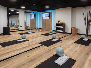 a room with yoga mats and balls on mats