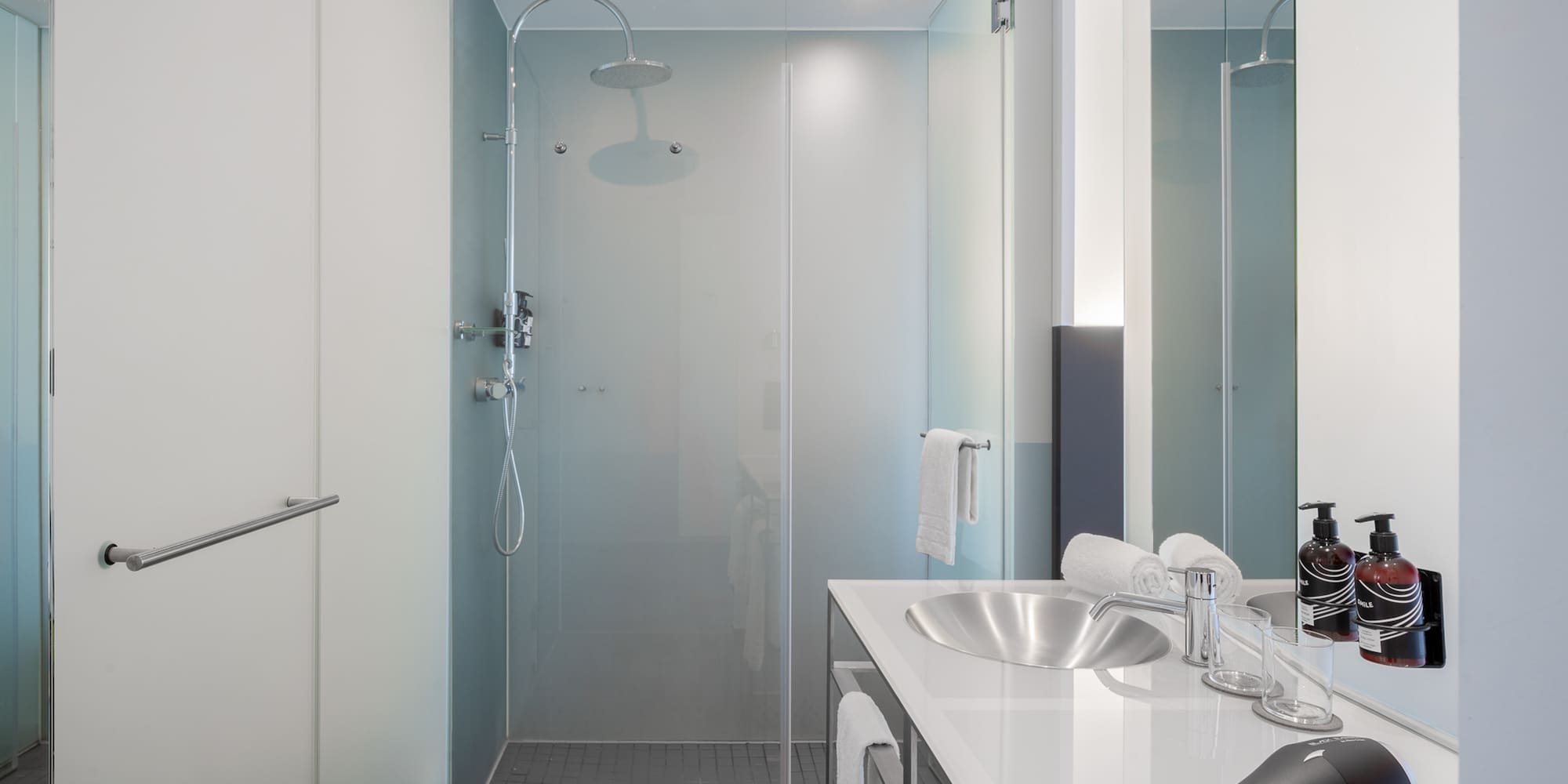 a bathroom with a shower and sink