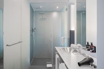 a bathroom with a shower and sink