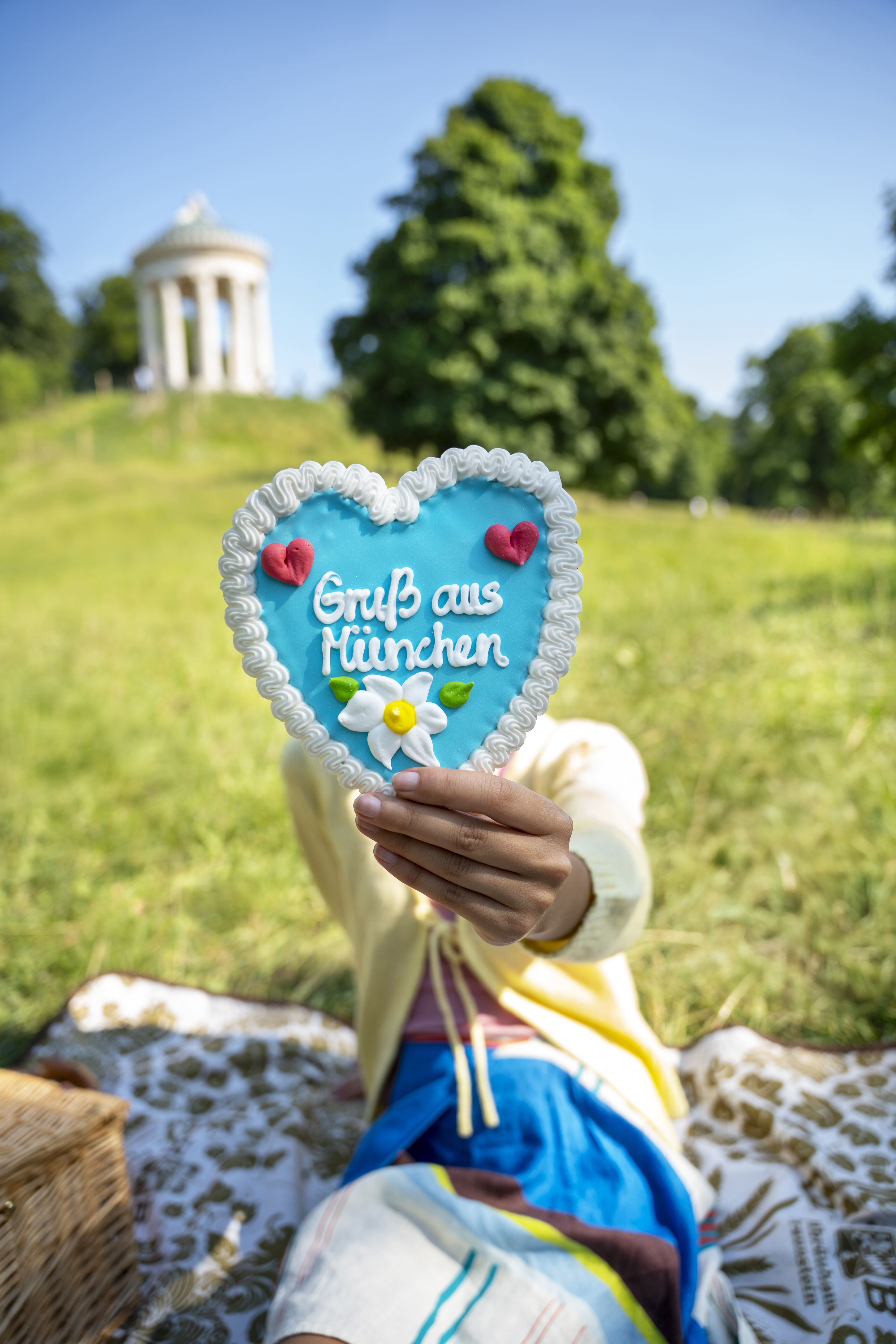 a person holding a heart shaped cookie