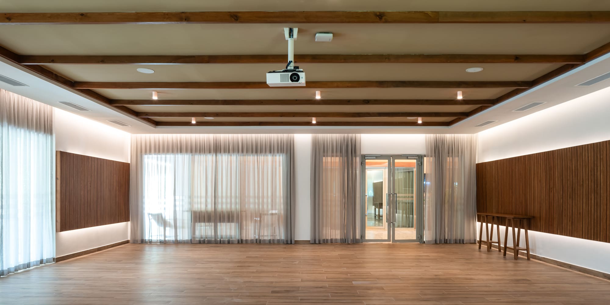 a room with wood floors and a projector