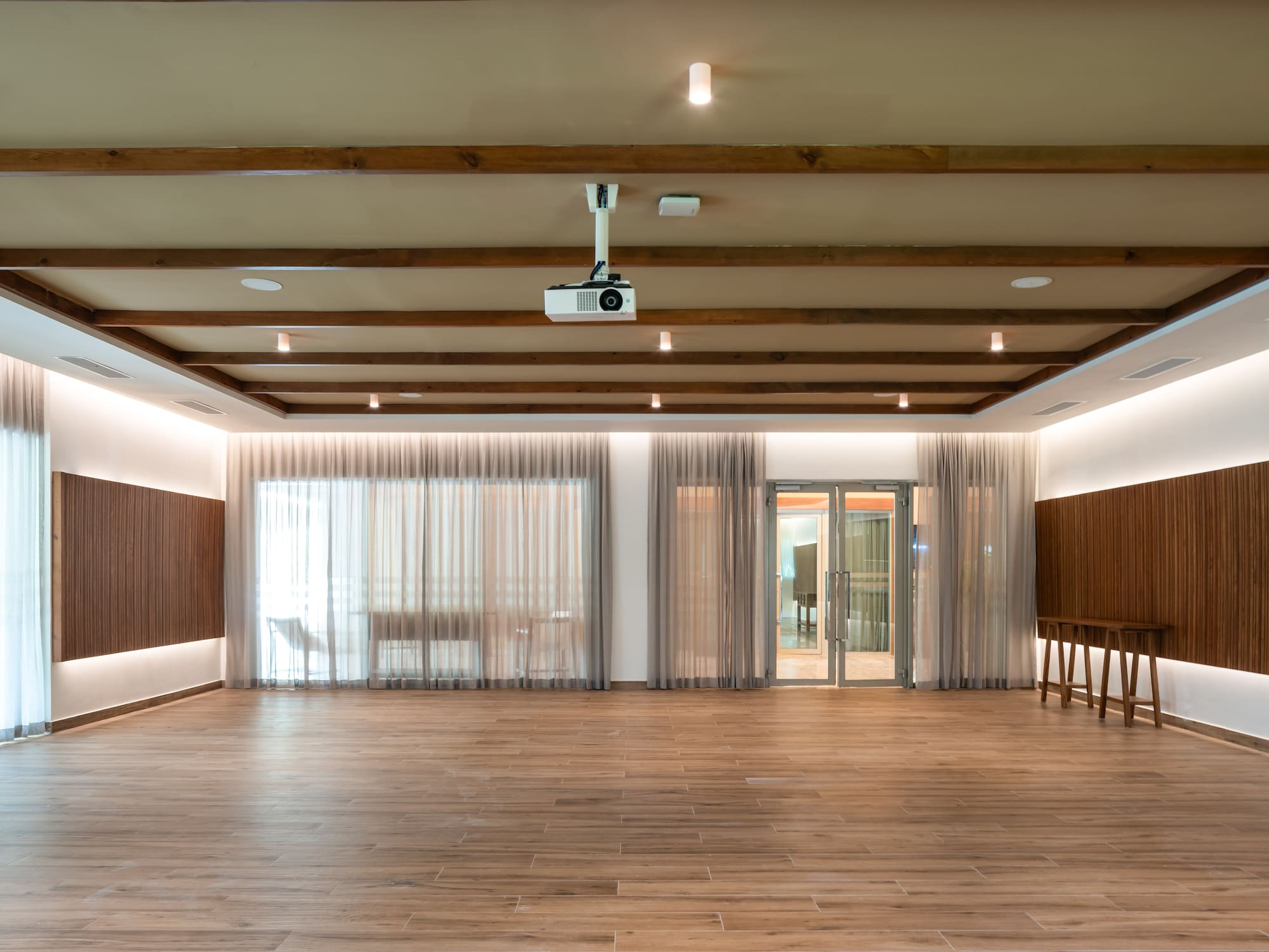a room with wood floors and a projector
