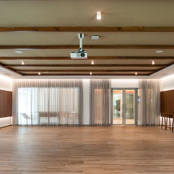 a room with wood floors and a projector