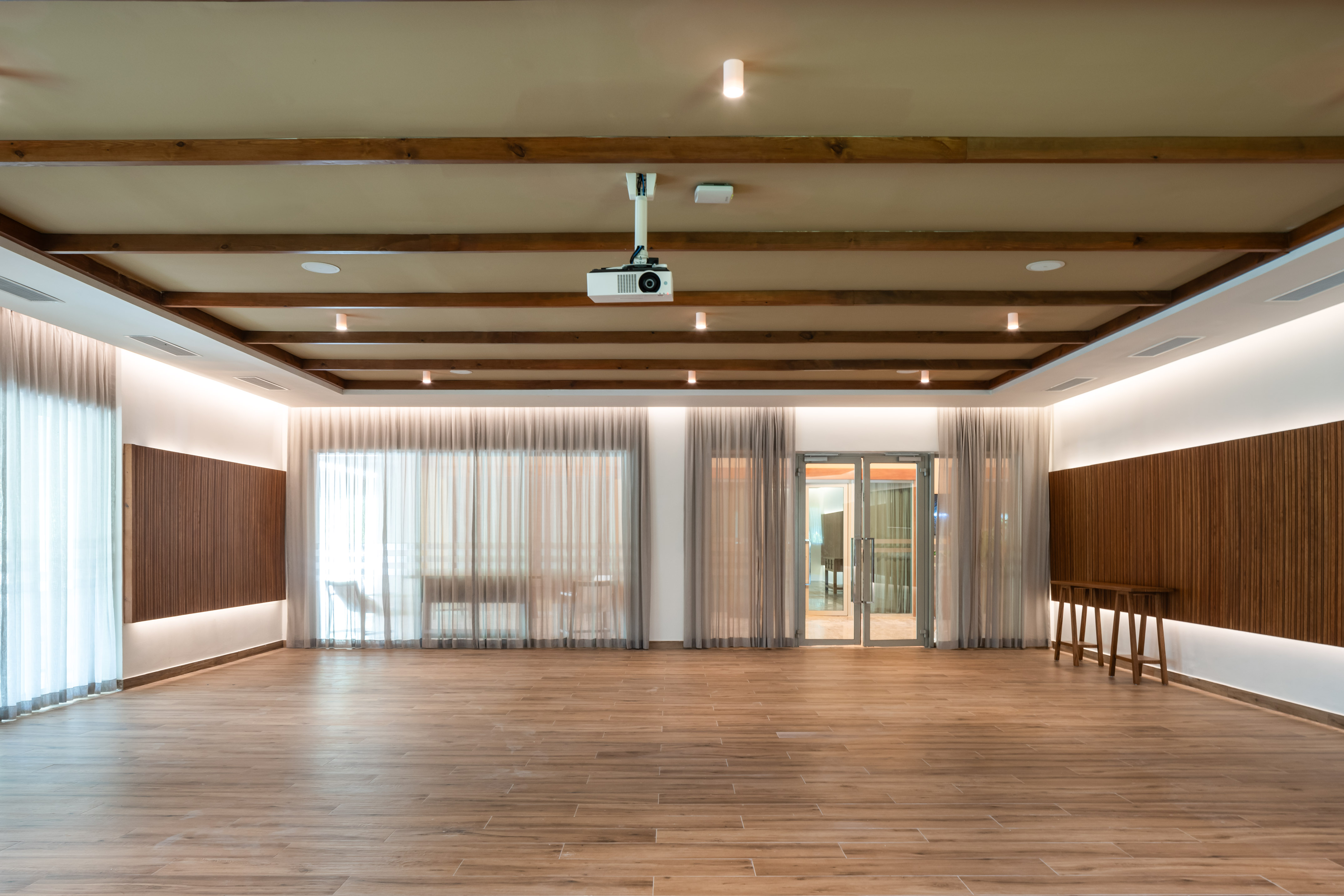 a room with wood floors and a projector