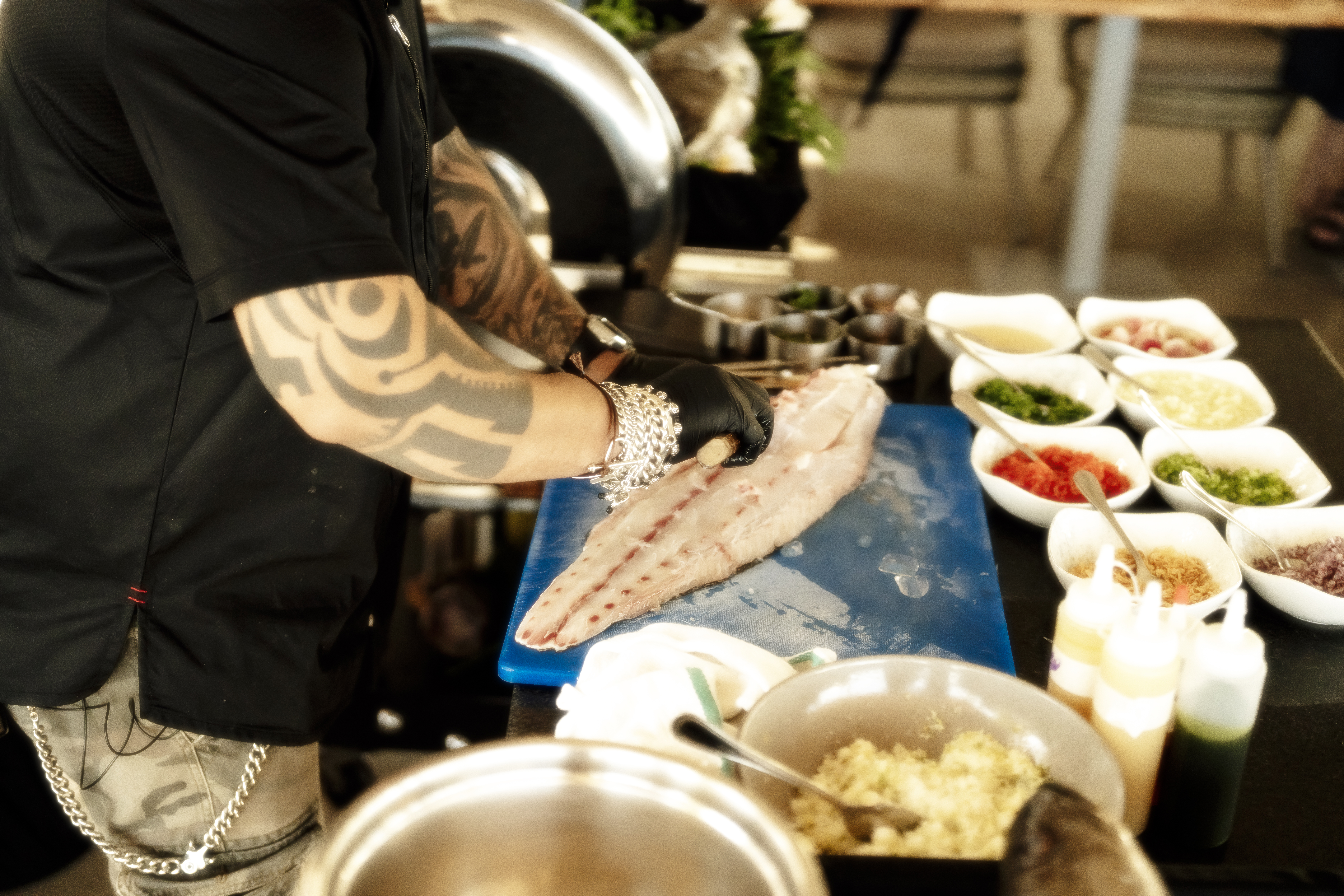 a person cutting fish on a cutting board