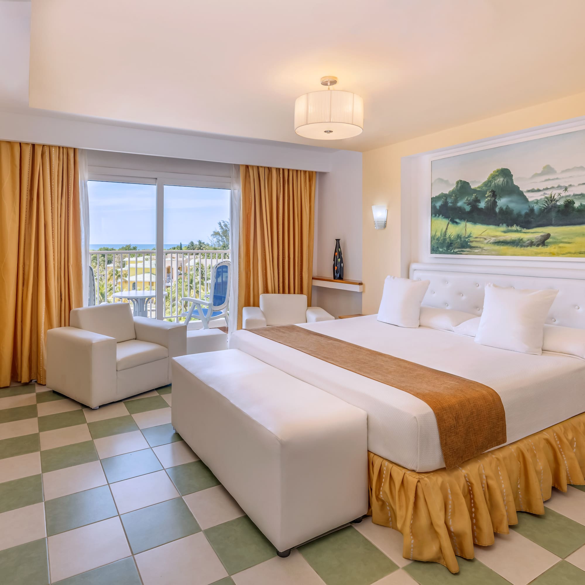 a room with a bed and chairs