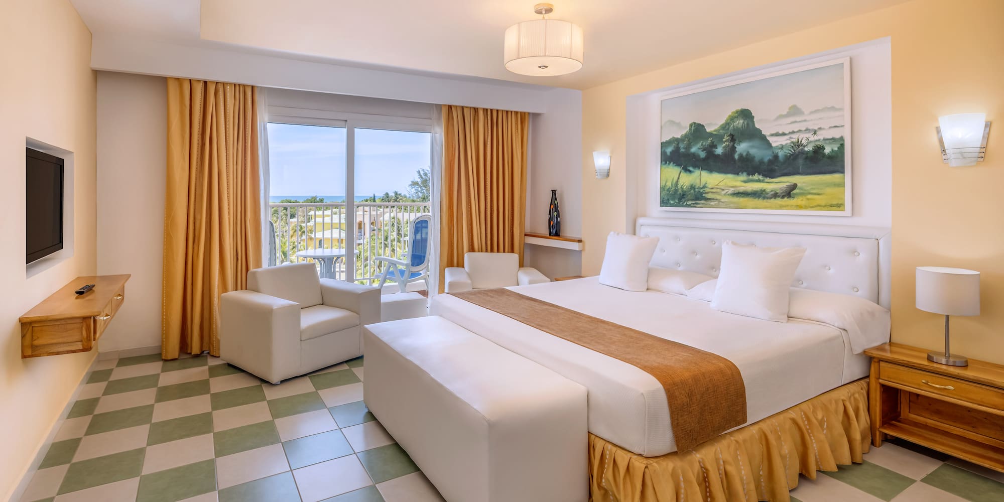 a room with a bed and chairs