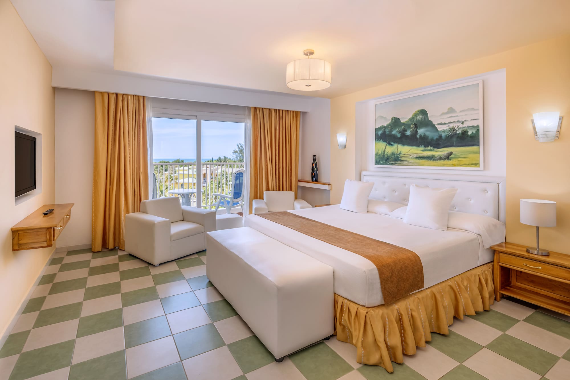 a room with a bed and chairs