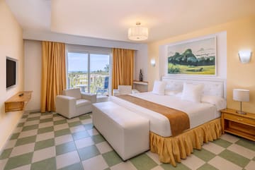 a room with a bed and chairs