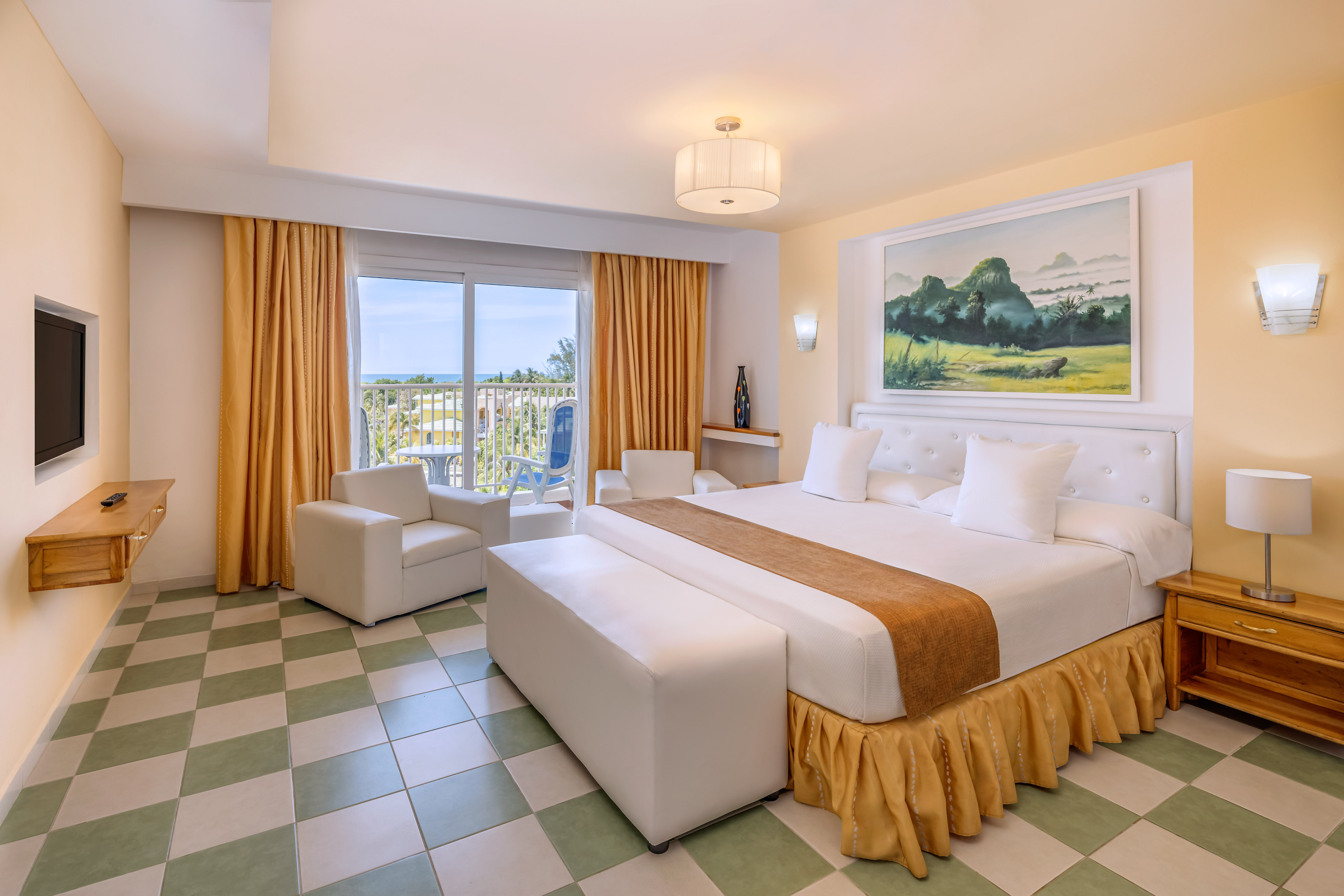 a room with a bed and chairs