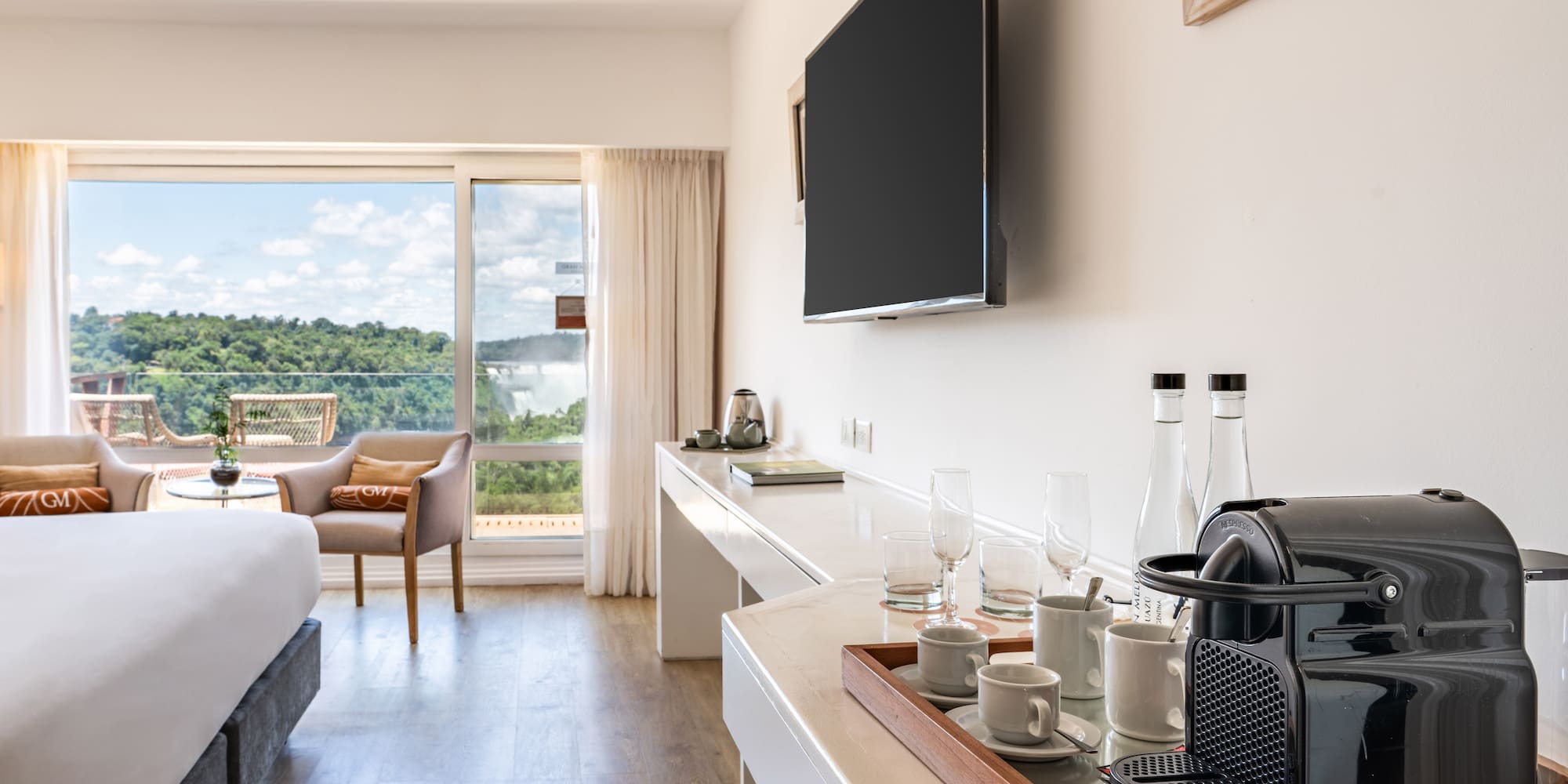 a room with a television and a bed and a window