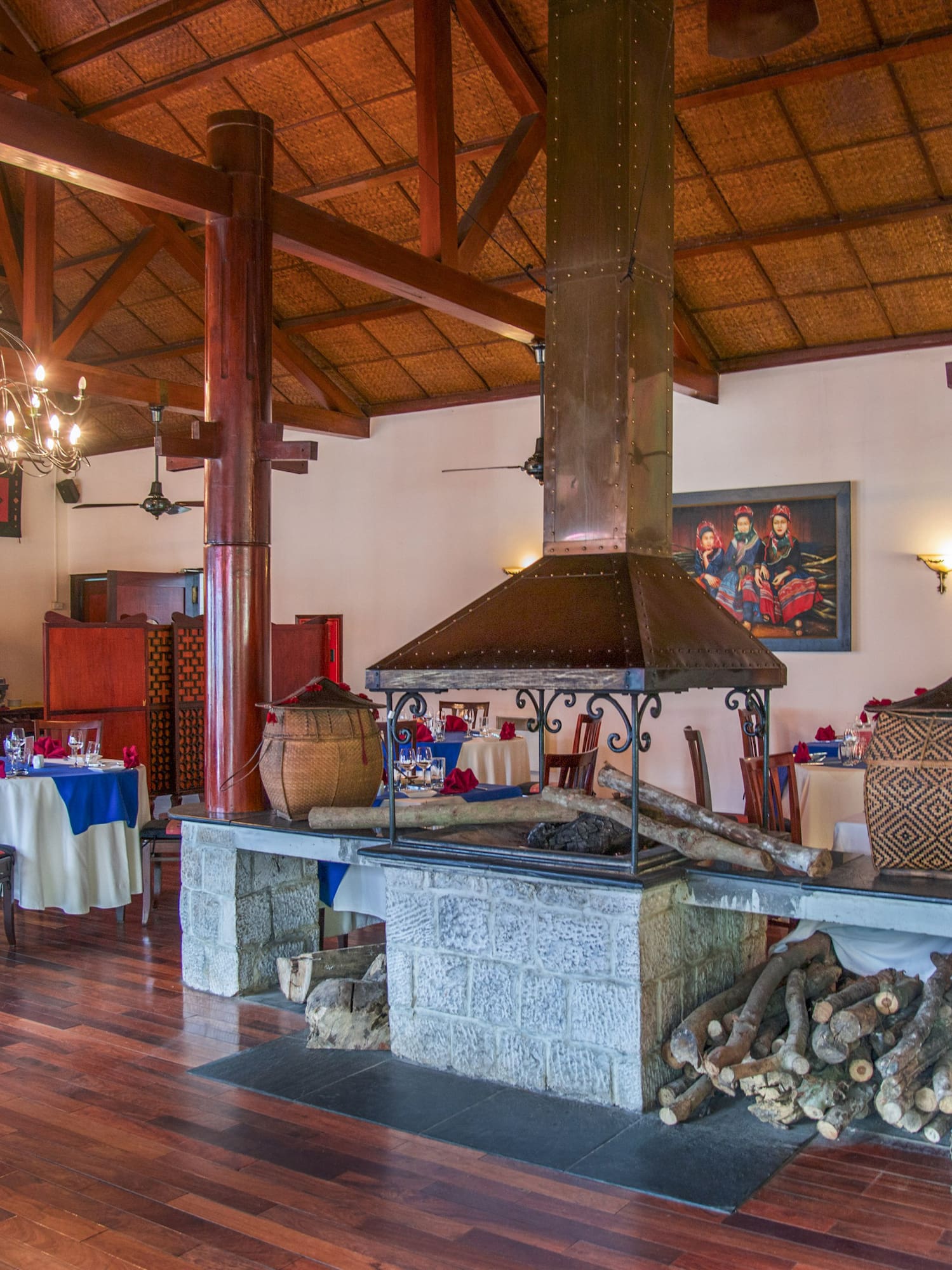 a room with wood beams and a fireplace