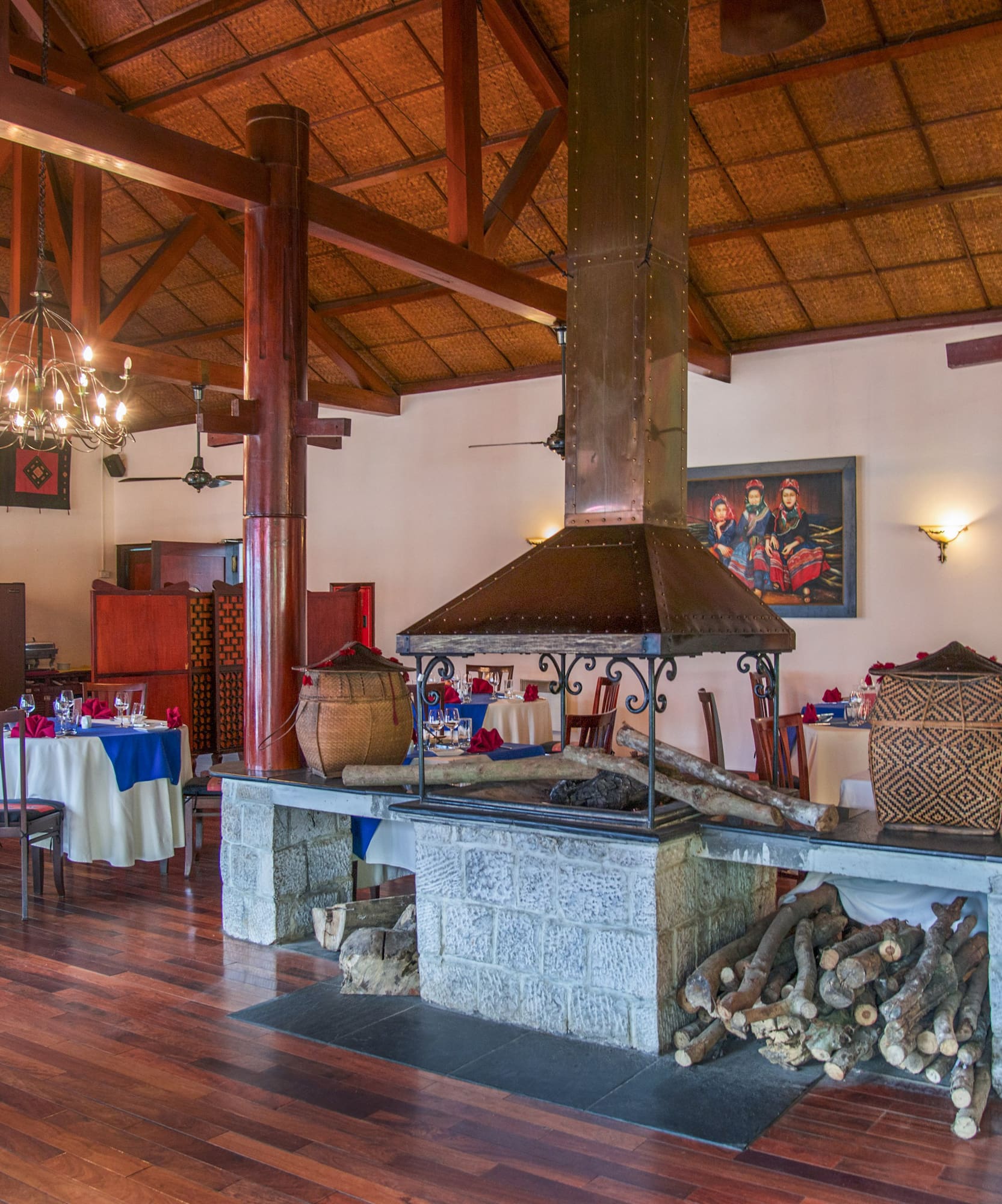 a room with wood beams and a fireplace