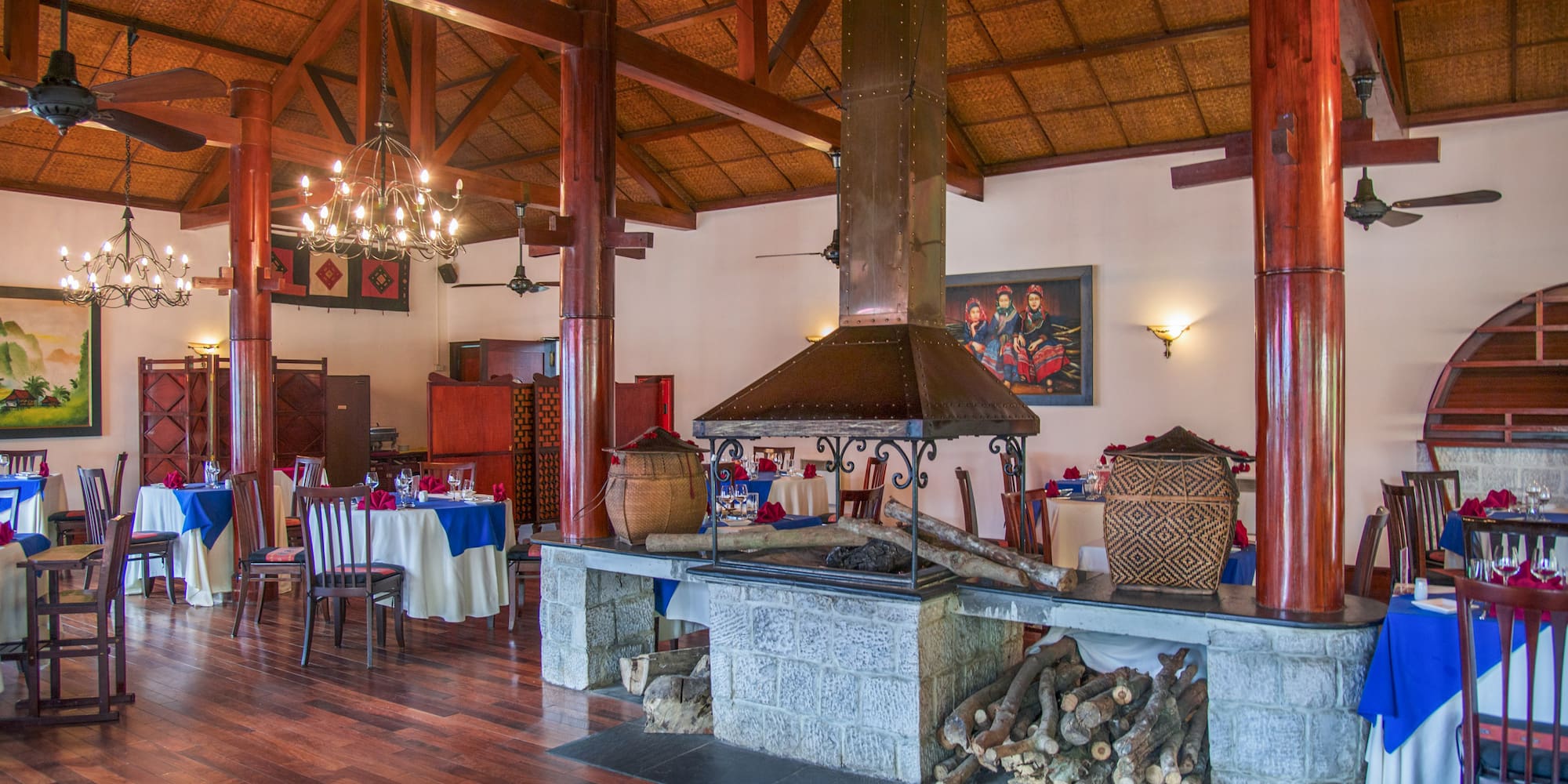 a room with wood beams and a fireplace