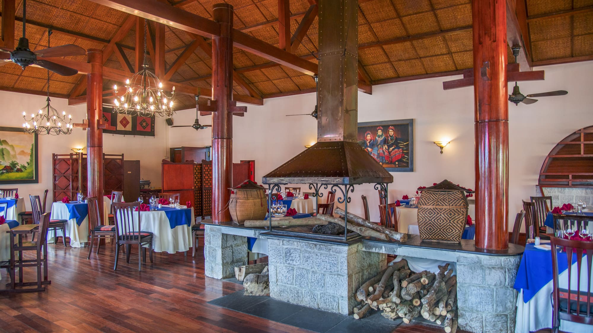 a room with wood beams and a fireplace