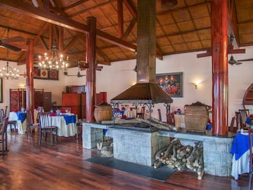a room with wood beams and a fireplace