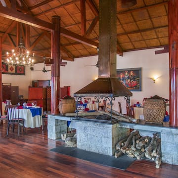 a room with wood beams and a fireplace