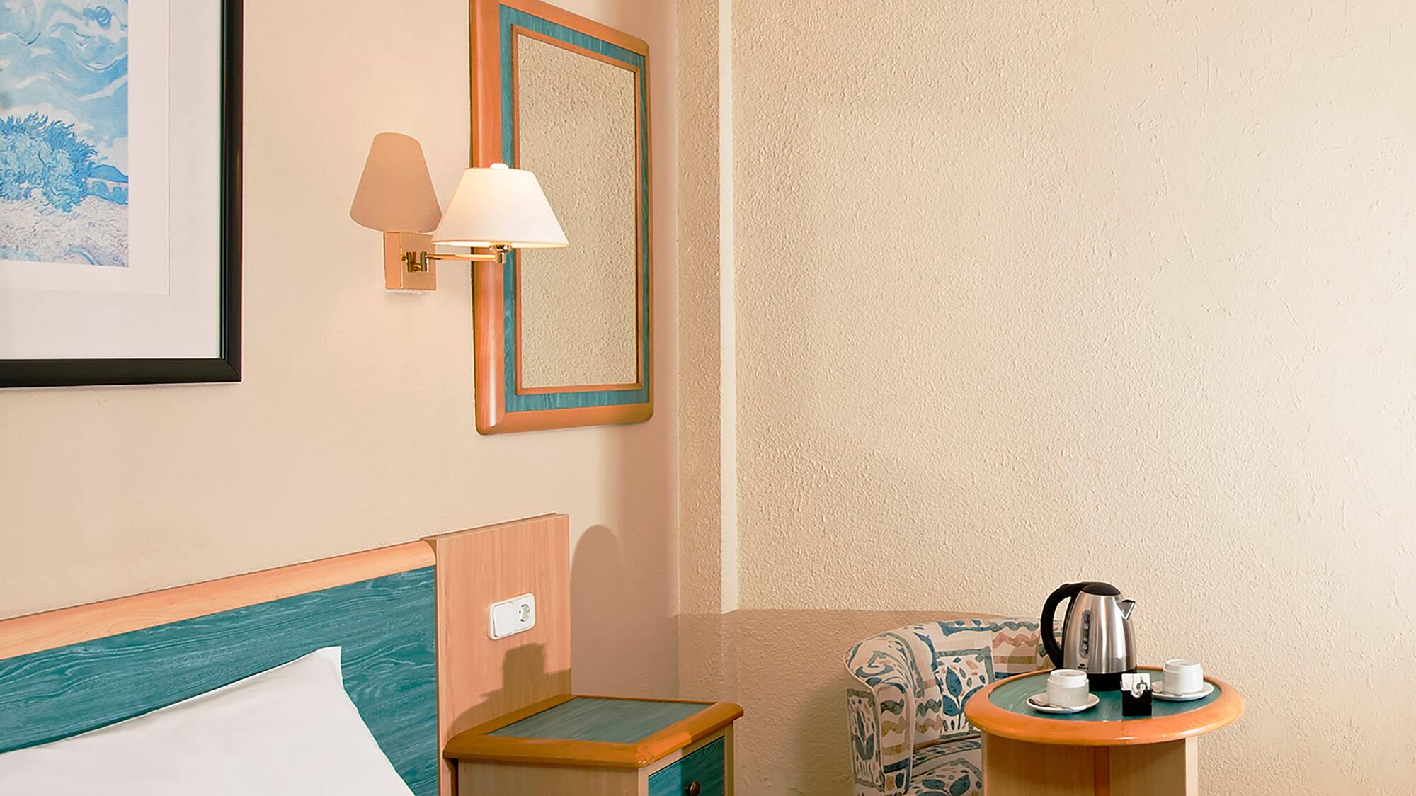 a room with a bed and a coffee pot