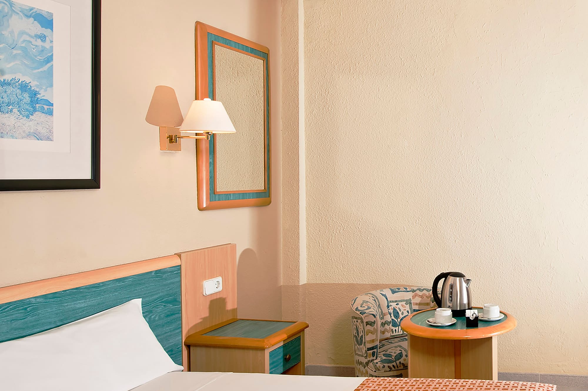 a room with a bed and a coffee pot