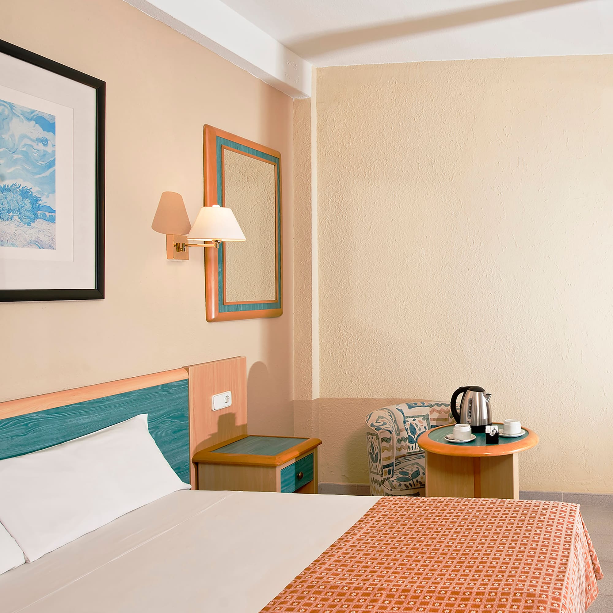 a room with a bed and a coffee pot