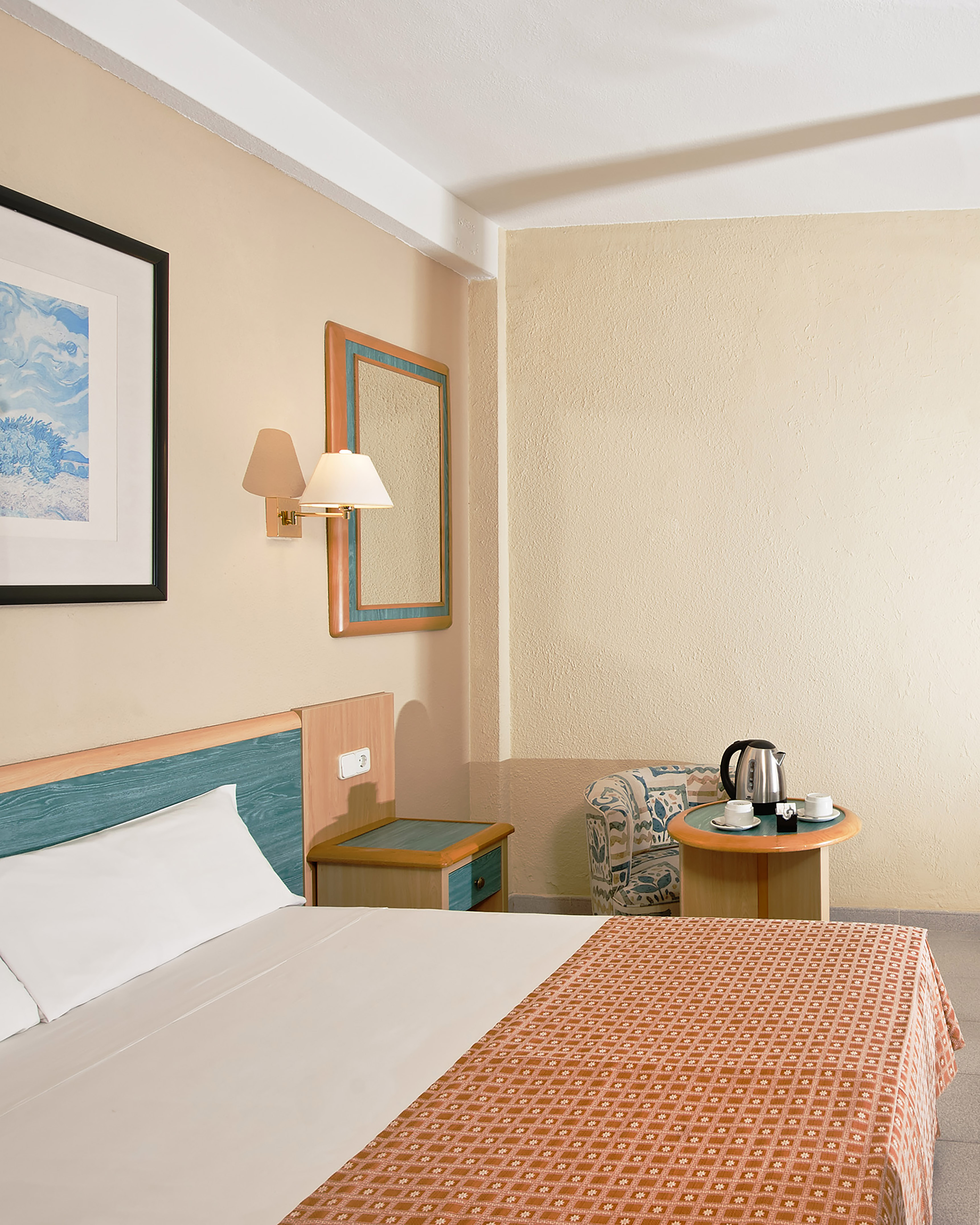 a room with a bed and a coffee pot