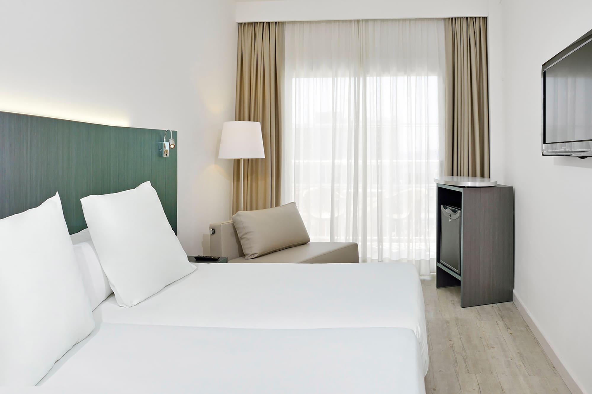 a room with two beds and a table