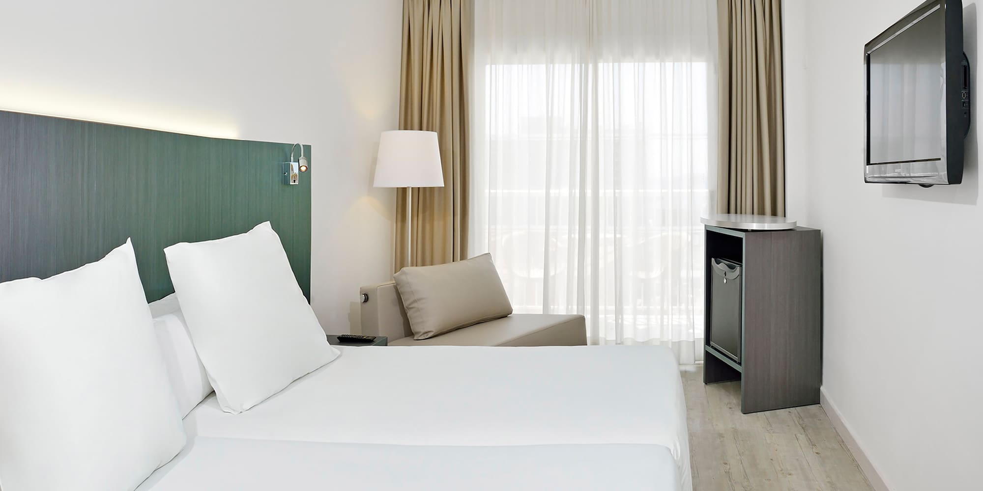 a room with two beds and a table