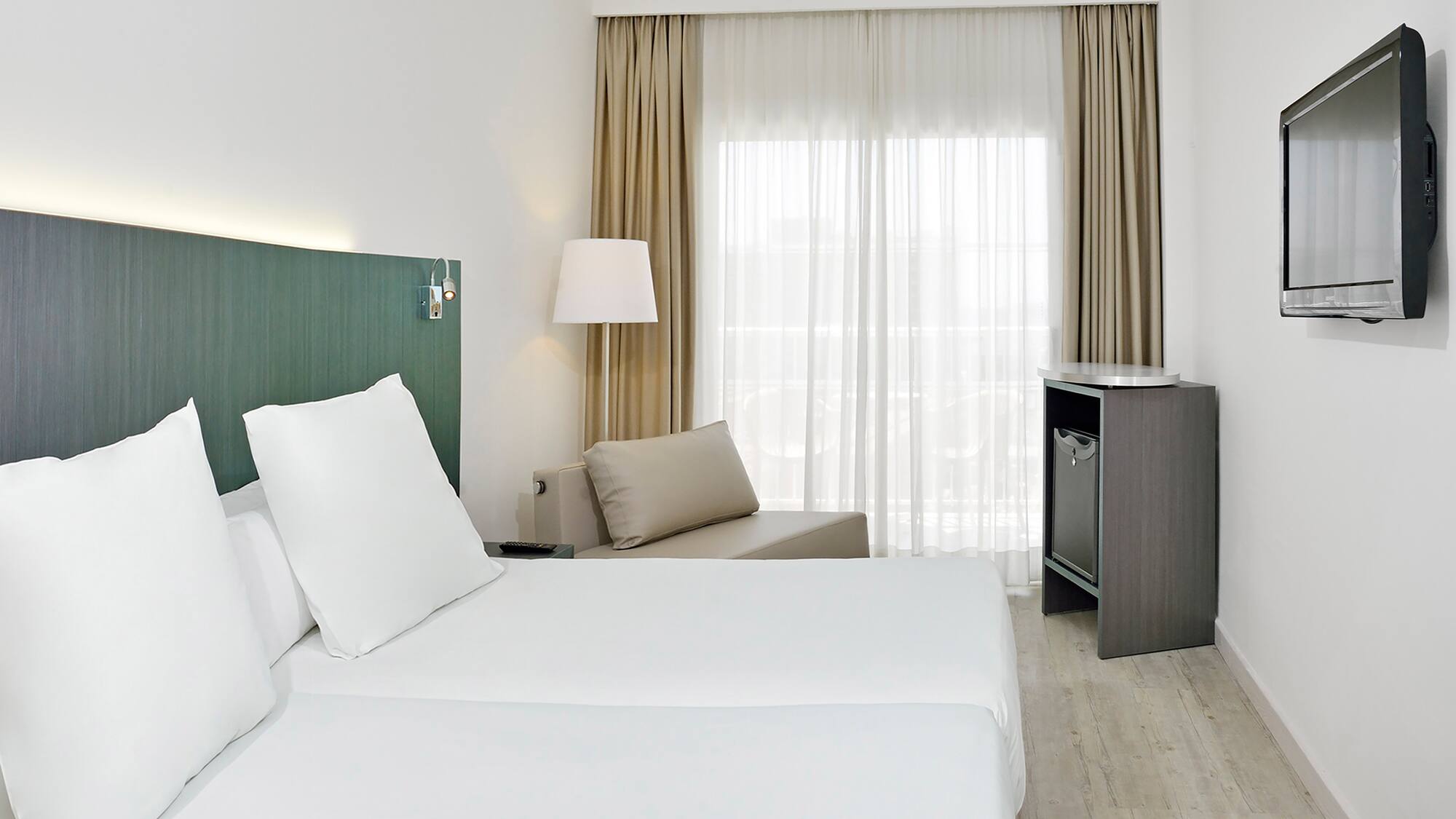 a room with two beds and a table