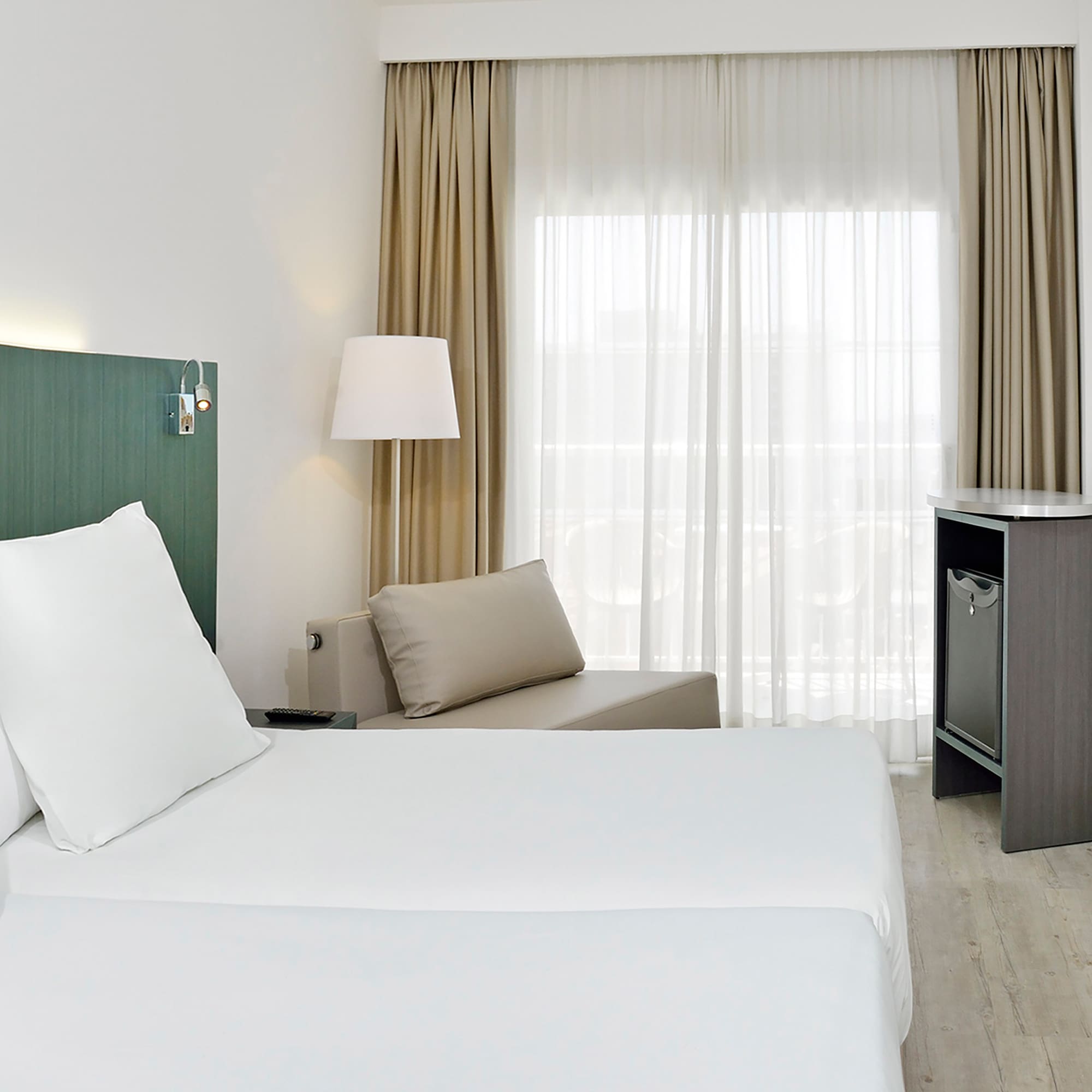 a room with two beds and a table