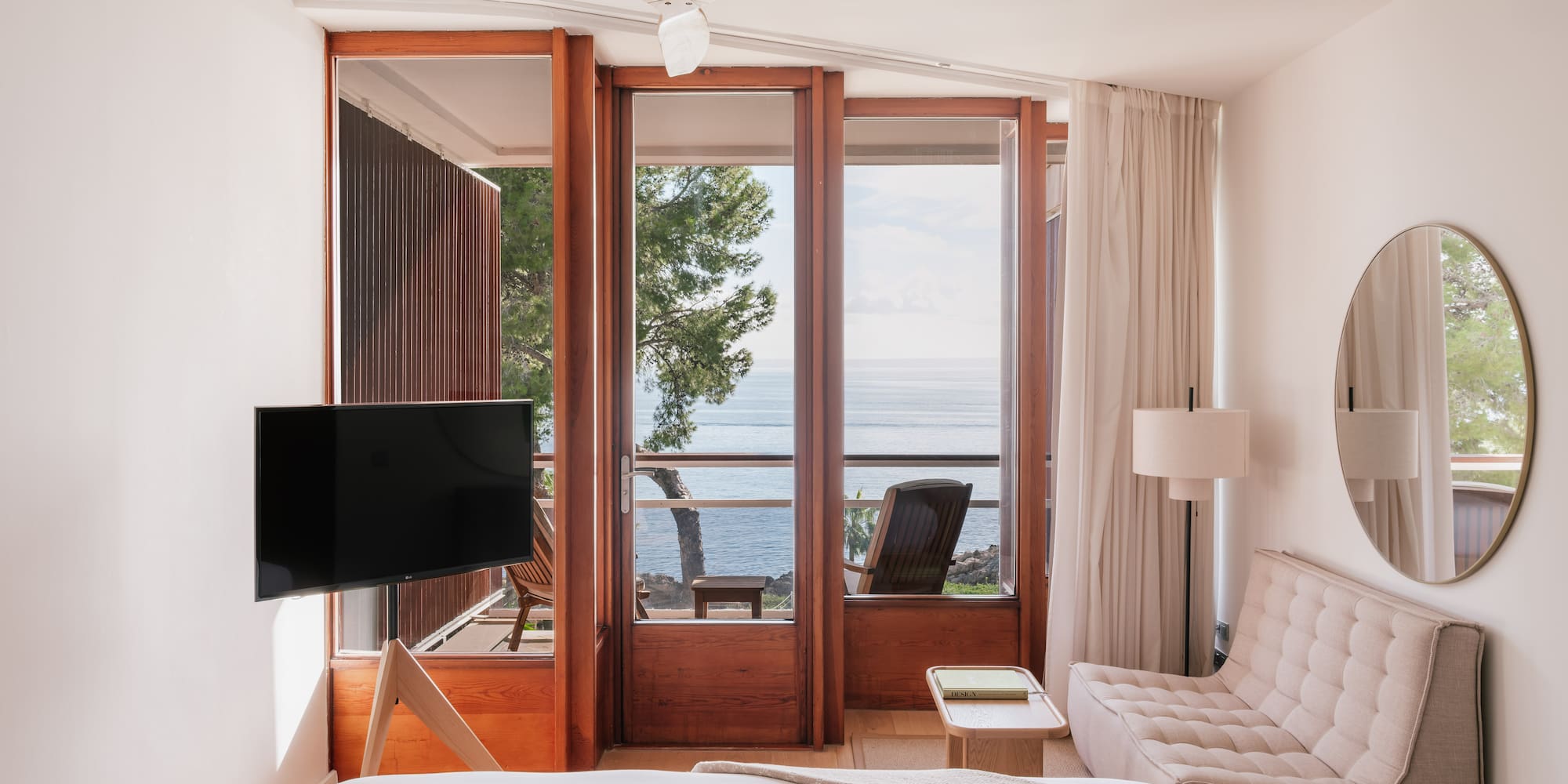 a bedroom with a television and a chair