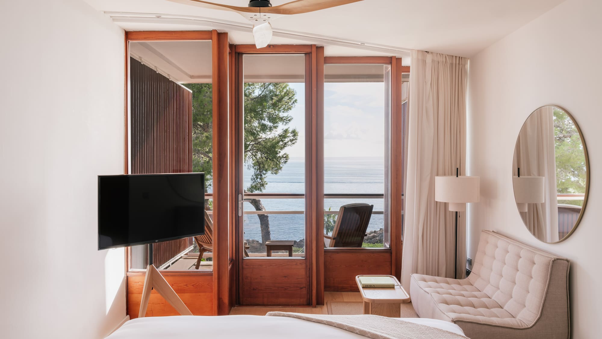 a bedroom with a television and a chair