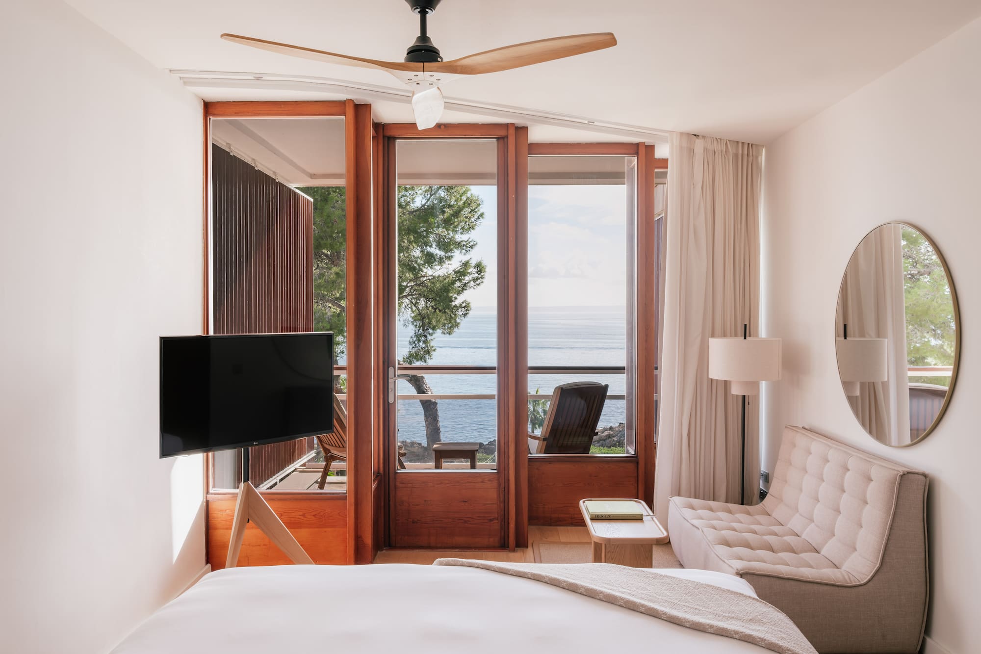 a bedroom with a television and a chair