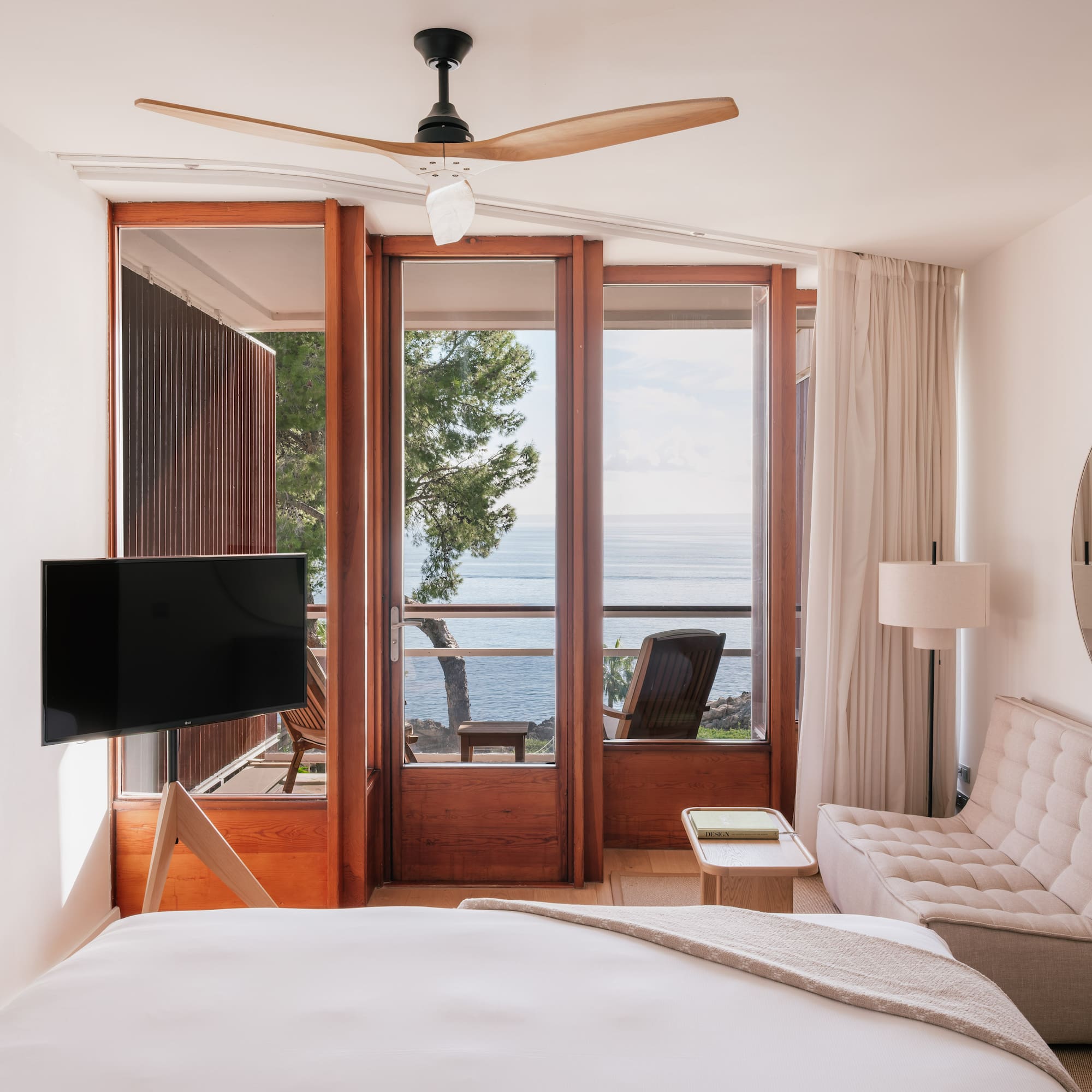 a bedroom with a television and a chair