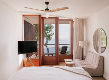 a bedroom with a television and a chair