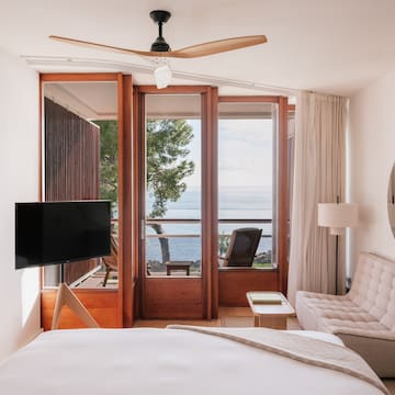 a bedroom with a television and a chair