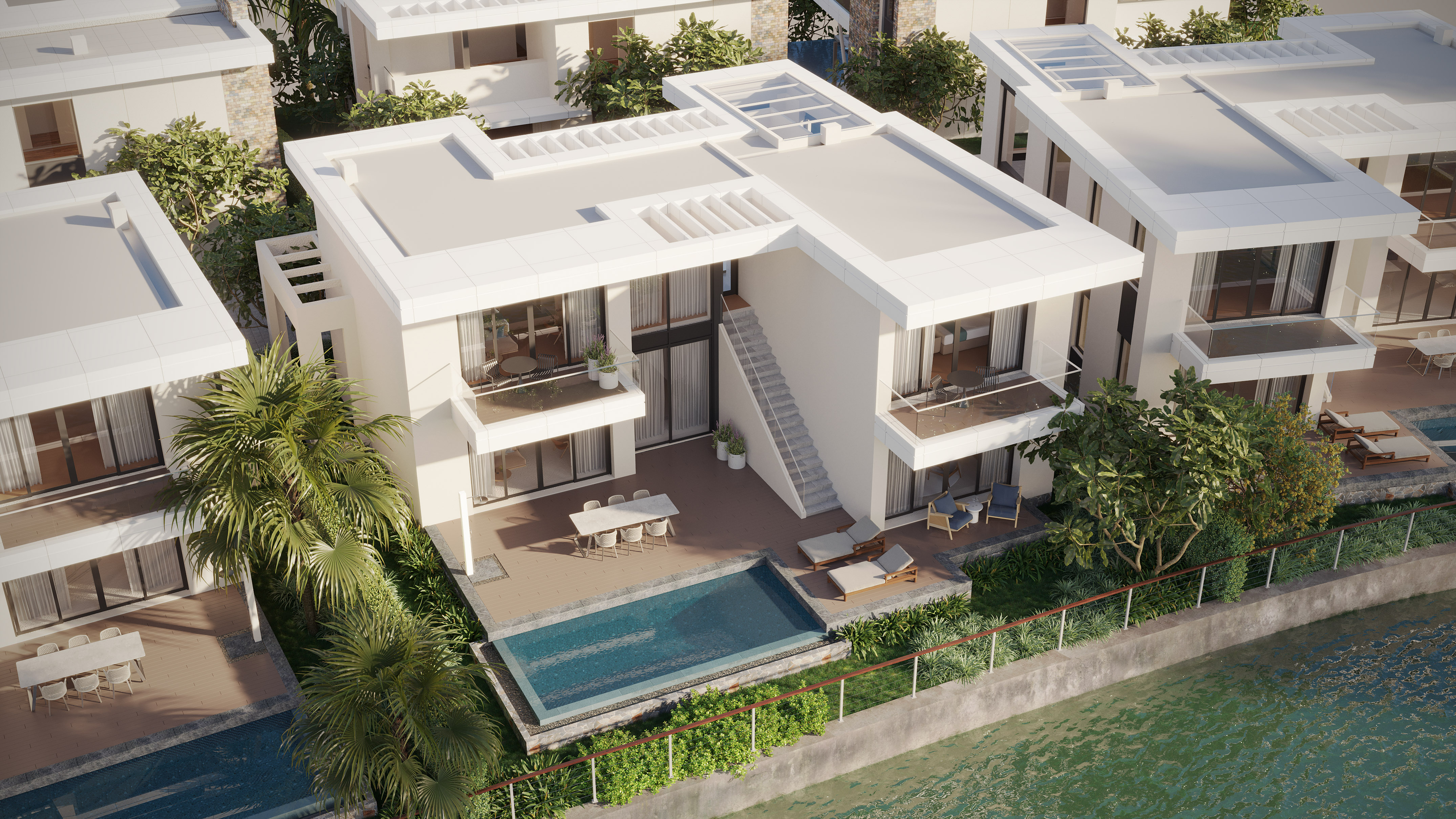 Aerial of modern waterfront villa, private pool, balconies, lush landscaping.