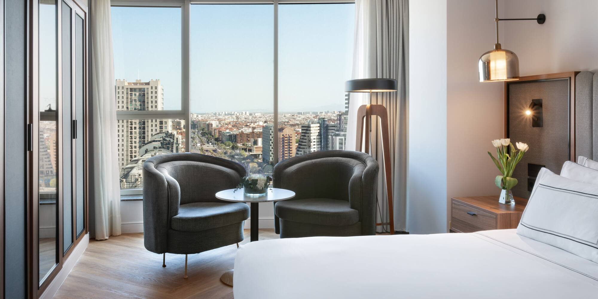 a room with a bed and chairs and a table