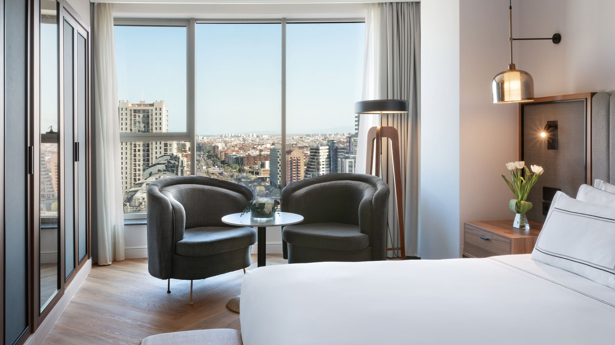 a room with a bed and chairs and a table