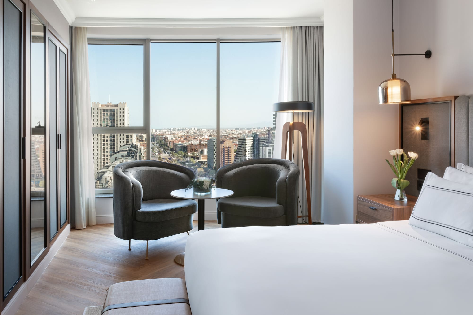 a room with a bed and chairs and a table