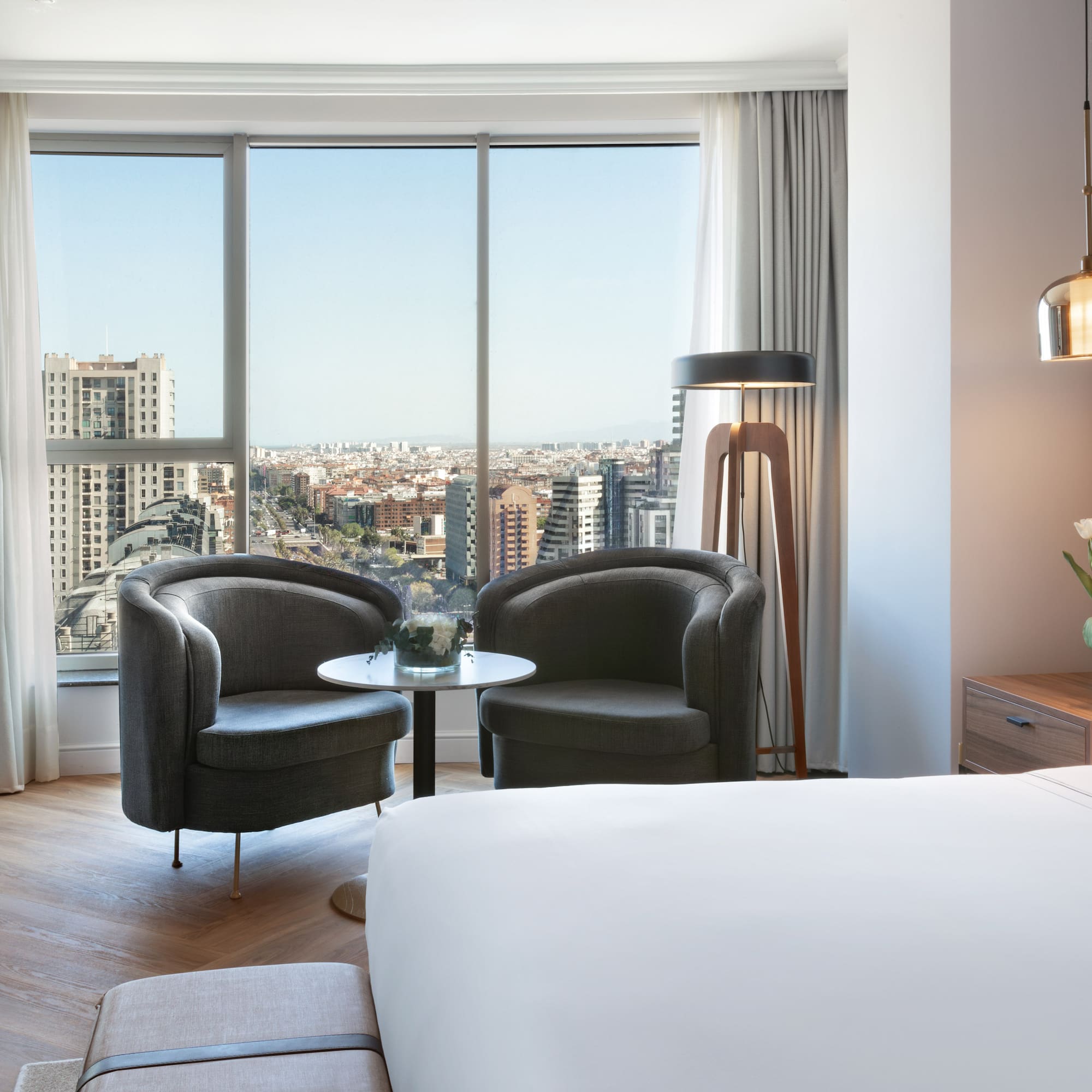 a room with a bed and chairs and a table