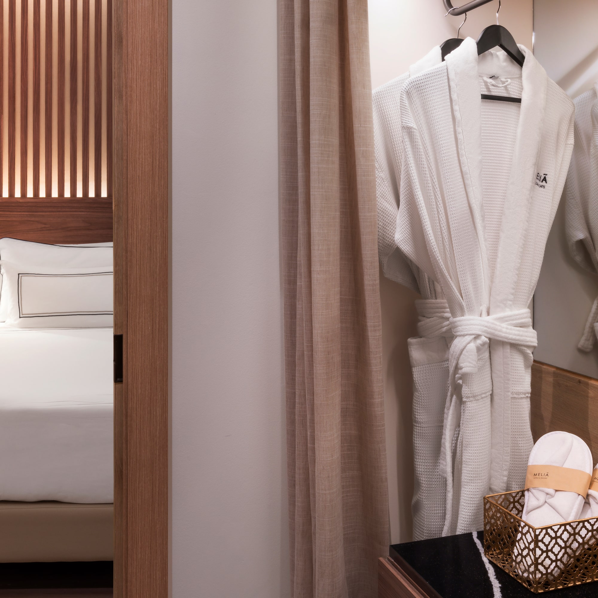 a white robe on a swinger in a hotel room