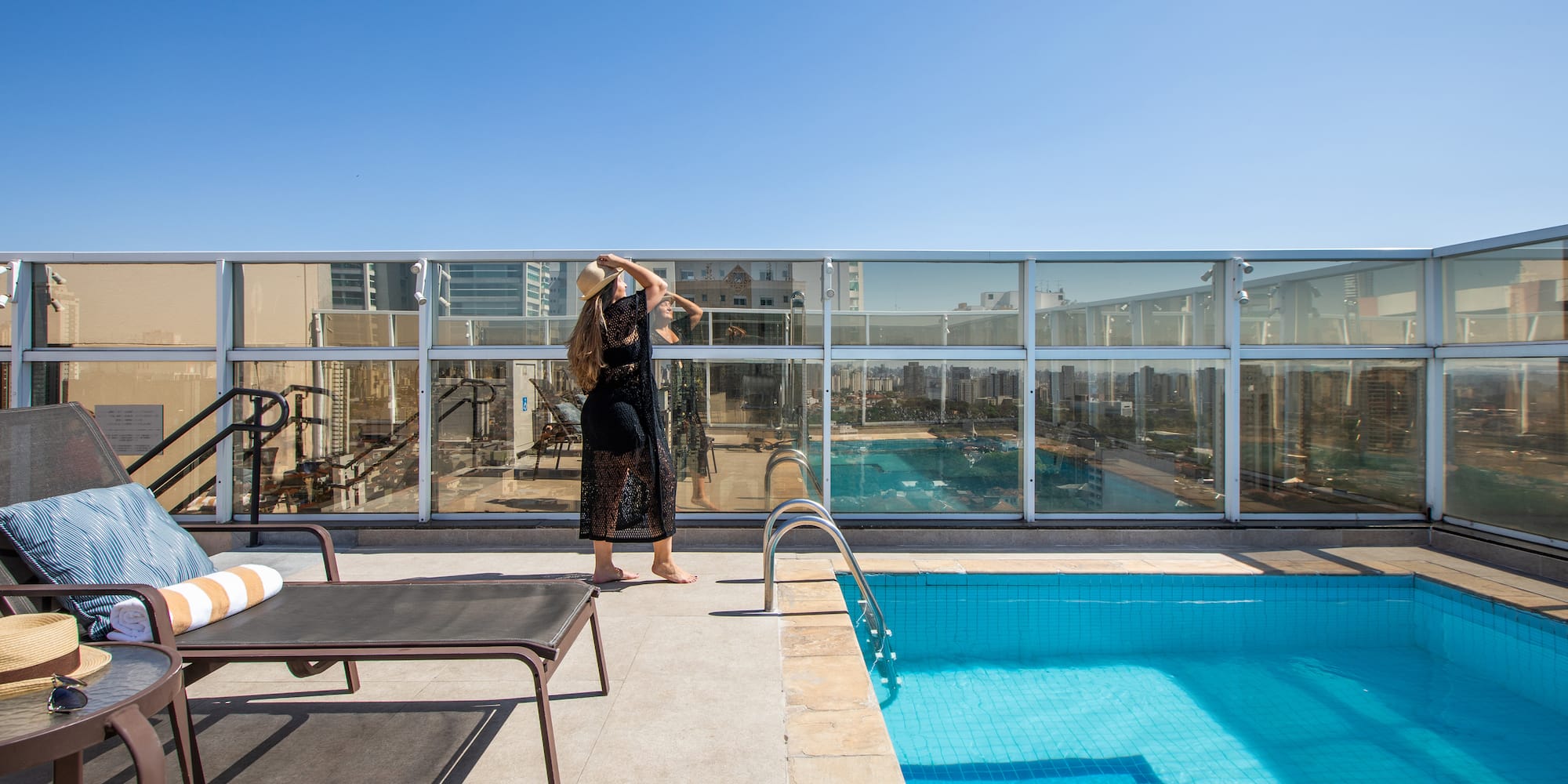 a woman standing by a pool