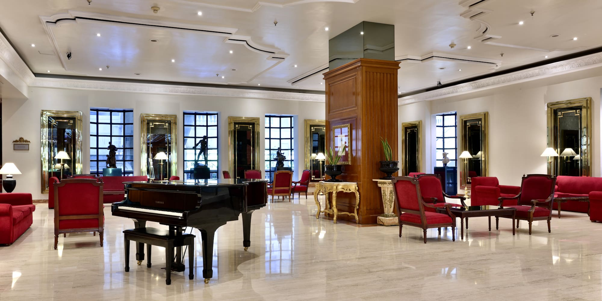 a room with a piano and chairs