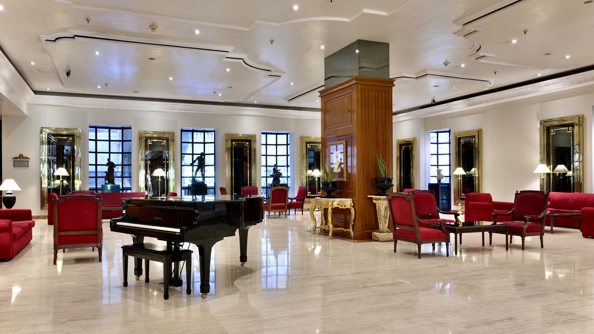 a room with a piano and chairs