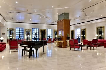 a room with a piano and chairs